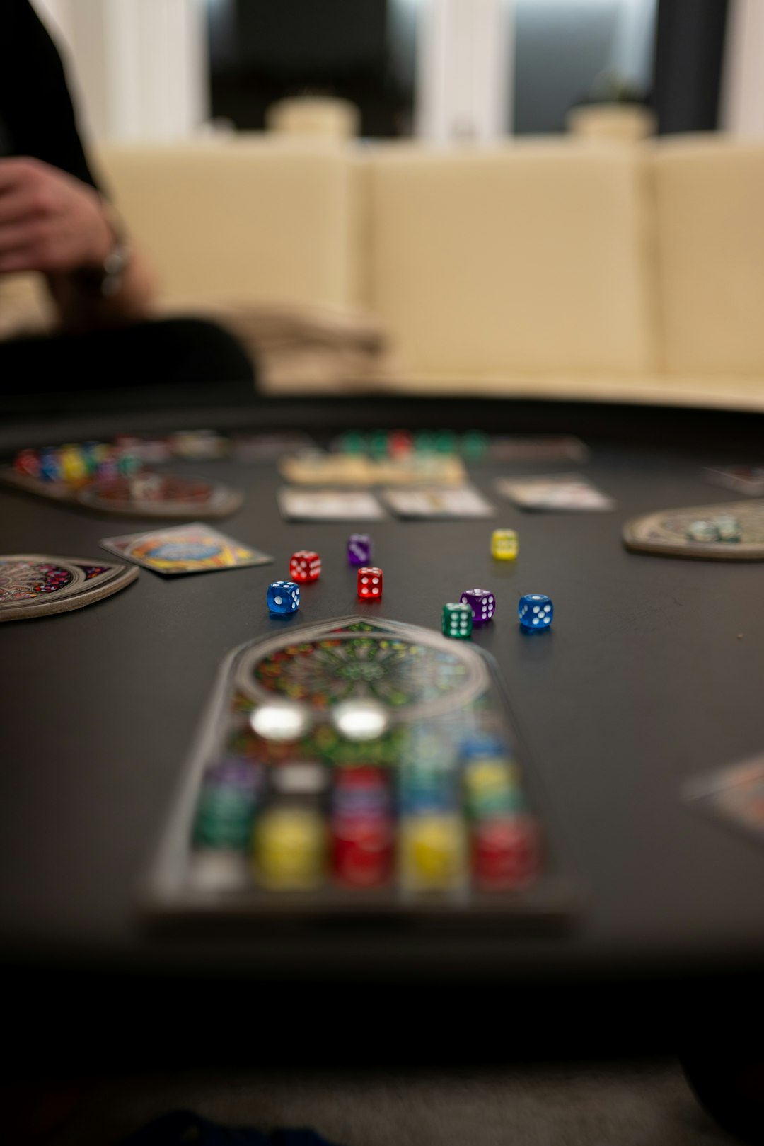 a-black-table-topped-with-lots-of-dice-3bdzm8liszm